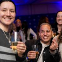Grads smile and cheers while taking a selfie